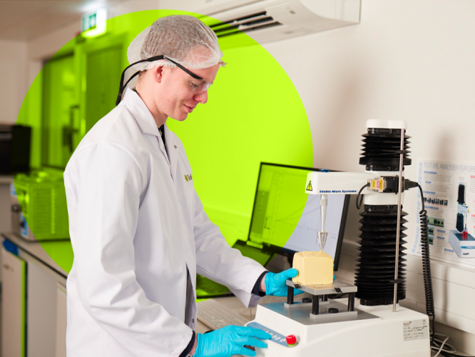 Man waering hair net and lab coat in a lab