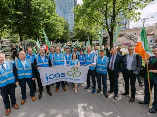 group of people holding an icos flag