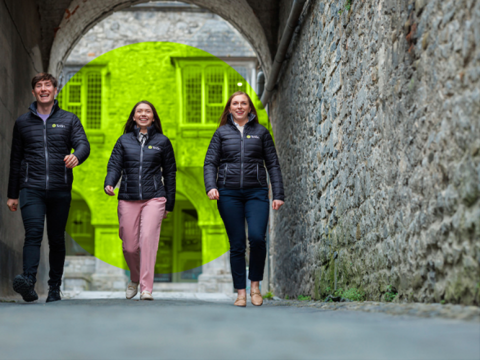 three people walking down a lane smiling